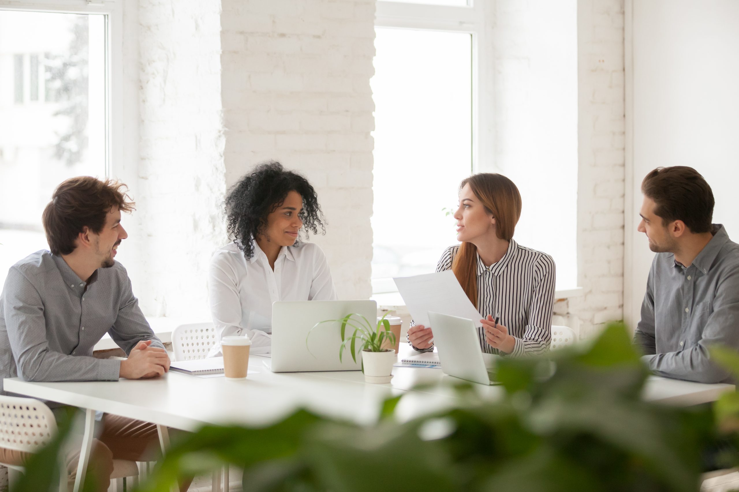 Multiracial male and female colleagues having discussion at team
